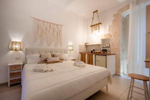 a bedroom with a large white bed with two towels on it at Dimora Giulia in Castellana Grotte