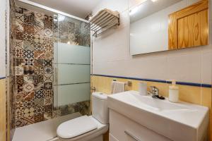 a bathroom with a white toilet and a sink at Villa picena las alpujarras in Picena +21 photos