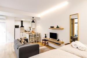 a living room with a couch and a kitchen at Ladomar Avenida in Horta