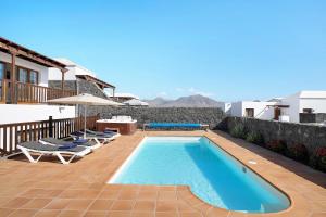 a villa with a swimming pool and a patio at Villa Jeamir I in Playa Blanca