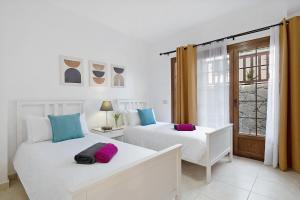 two white beds in a room with a window at Villa Jeamir I in Playa Blanca +17 photos