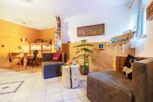 a living room with a couch and a table at Hatzes App Schlern in Laion