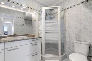 a bathroom with a shower and a toilet and a sink at Bungalow Seaview in San Bartolomé +13 photos