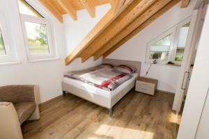 a bedroom with a bed and two windows at Ferienwohnung Stratmann in Lennestadt