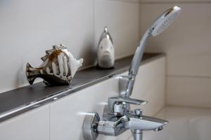 a bathroom sinkaucet with a baseball glove on a shelf at Ferienwohnung Stratmann in Lennestadt +14 photos