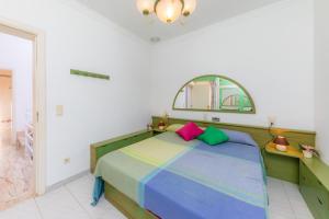 a bedroom with a bed with colorful pillows at Ca Na Xisca in Sa Coma +28 photos