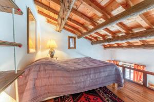 a bedroom with a bed in a room with wooden ceilings at Au Fil Des 5 Saisons in Vers Pont du Gard +35 photos