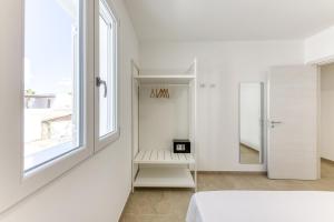 a white room with a bed and a window at Residence Fronte Mare in Ugento +137 photos