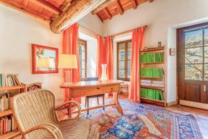 a home office with a wooden desk and chairs at Au Fil Des 5 Saisons in Vers Pont du Gard
