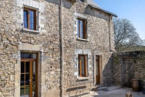a stone building with a bench in front of it at Chambres d'hôtes Le Plessis in Frossay