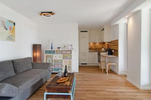 a living room with a couch and a table at Ferienwohnung Gartenblick in Herdwangen-Schönach