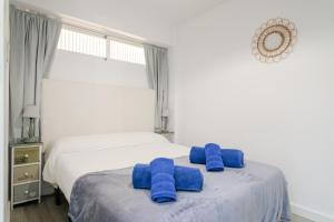 two blue towels sitting on a bed in a bedroom at Boliche in Benimagrell +16 photos