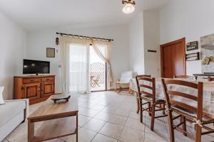 a living room with a couch and a table at Casa Perla in Villasimius