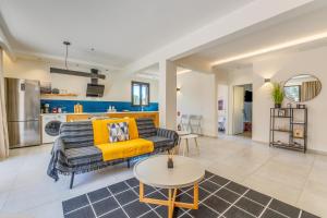 a living room with a couch and a table at Eirini's Apartment in Kanoni