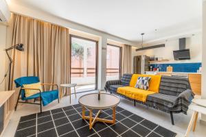 a living room with a couch and a table at Eirini's Apartment in Kanoni