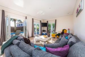 a living room with a couch and a table at Villa Amarador in Santanyi