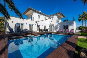 a swimming pool in front of a house at Villa Amarador in Santanyi