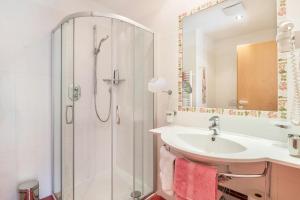 a bathroom with a shower and a sink at Haus Rosengarten Apt A in Terlano +24 photos
