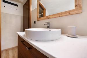 a bathroom with a white sink on a counter at Le Volte - Lago D'Iseo in Pisogne