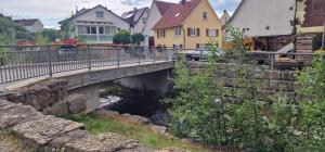 a bridge over a river in a town with houses at M B Homes Schlatt 2 Worker House in Hechingen