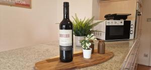 a bottle of wine sitting on top of a counter at M B Homes Schlatt 2 Worker House in Hechingen +9 photos