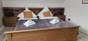 a bedroom with a large bed with two pillows at M B Homes Schlatt 2 Worker House in Hechingen