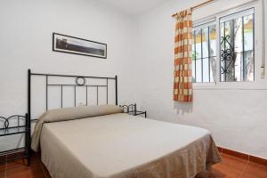 a bedroom with a bed and a window at Casa Paqui 1 in Roche +19 photos
