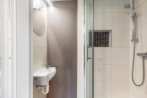 a bathroom with a sink and a shower at Green wonder in Friedrichsdorf +26 photos