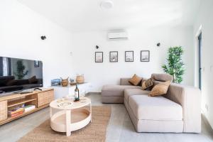 a living room with a couch and a table at Portimao riverview T2 luxe 1 floor in Portimão
