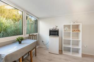 a dining room with a table and a window at Green wonder in Friedrichsdorf
