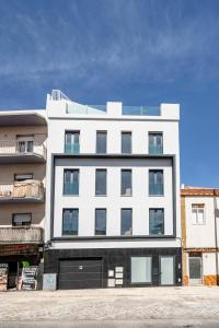 a white building with a lot of windows at Portimao riverview T2 luxe 1 floor in Portimão