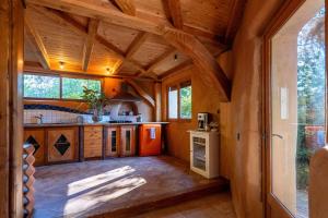 a large kitchen with wooden ceilings and wooden counters at Gîte Écologique - Le Nid des Anges in Saint-André-Lachamp +26 photos
