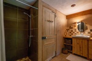 a bathroom with a shower with a glass door at Gîte Écologique - Le Nid des Anges in Saint-André-Lachamp