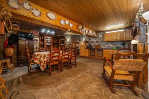 a dining room with a table and wooden chairs at Horta Do Zé Miguel in Monchique +40 photos