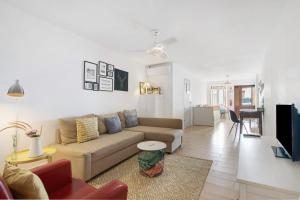 a living room with a couch and a table at Casa Amarela in Tavira