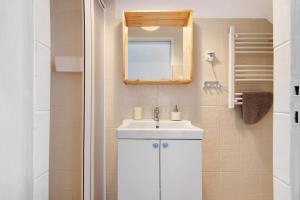 a bathroom with a white sink and a mirror at Casa Amarela in Tavira +12 photos