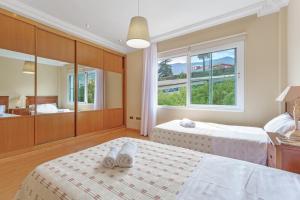 a bedroom with two beds and a large window at Villa Teide in La Orotava