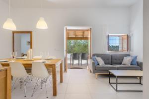 a living room with a table and a couch at Ca Ses Celleres in La Mola