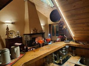 a kitchen with two glasses of wine on a counter at Baita Le Pozze in Abetone