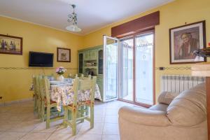 a dining room with a table and chairs and a tv at Casa Angel in Galatone
