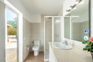 a bathroom with a sink and a toilet at Ca Ses Celleres in La Mola +27 photos