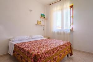 a bedroom with a bed and a window at Casa Angel in Galatone