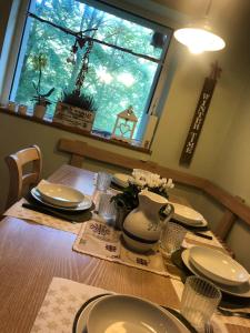 a dining room table with plates and a vase on it at Baita Le Pozze in Abetone +27 photos