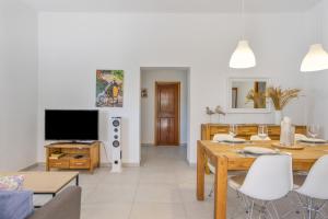 a living room with a table and a television at Ca Ses Celleres in La Mola