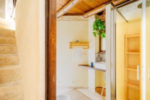a bathroom with a toilet and a glass door at Dimora Pisanelli in Specchia