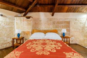 a bedroom with a bed with two lamps on tables at Dimora Pisanelli in Specchia