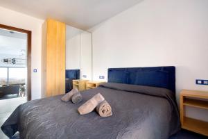 a bedroom with a bed with two pillows on it at My Favorite Home in Caleta De Fuste