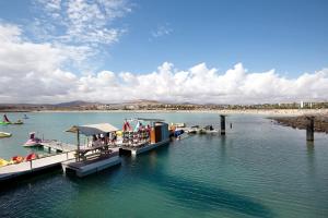 a group of people on a dock in the water at My Favorite Home in Caleta De Fuste