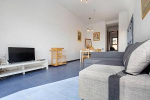 a living room with a couch and a flat screen tv at My Favorite Home in Caleta De Fuste