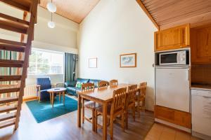 a kitchen and dining room with a table and chairs at Santa's Hotel Tunturi in Saariselka